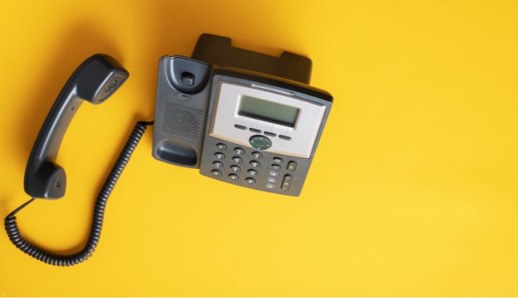 A caption phone against a yellow background.